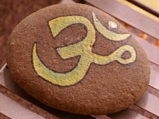 An image of an OM on a rock from Kigar Yoga